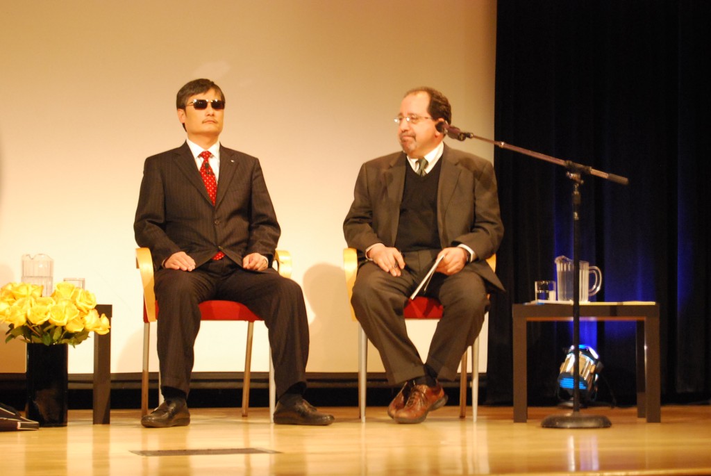 Chen sits next to Ira Belkin, executive director of the U.S.-Asia Law Institute at NYU Law, who translated for him at Tishman Auditorium on February 6.