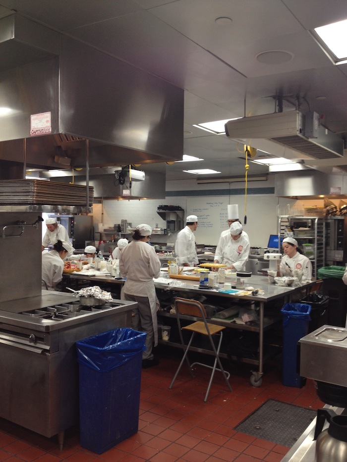 Classic Pastry Arts students practice decorating layered cakes.
