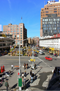 The square on 14th Street and Hudson Avenue showcases fashion retail stores beneath and alongside offices of new tech startups, as well as the former Port Authority Inland Terminal 1 building, which is now the home of Google’s NYC headquarters (Henry Miller)