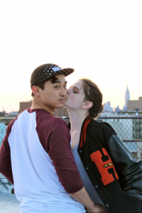 Ji-Hoon Lee receives an affectionate smooch from girlfriend Carry Widmer on her roof in Brooklyn. “We already made an agreement that when we spend time together, it’s going to be happy,” Lee said, referring to his  impending military service. (Henry Miller)