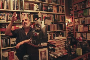 Michael Seidenberg, the owner of Brazenhead Books, stands behind his makeshift bar and converses with customers. Photo by Ivy Meissner