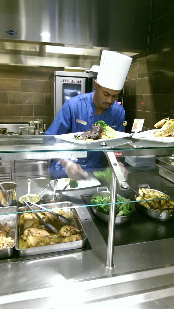 As the dinner hour draws nearer at the UC Café, the kitchen staff works faster and faster to satisfy the students' rapidly swelling appetites.