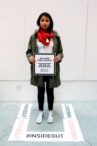 Parsons student wears a red scarf and green jacket inside out in order to support who made their clothes for the event. Photo By: Cayla O'Connell