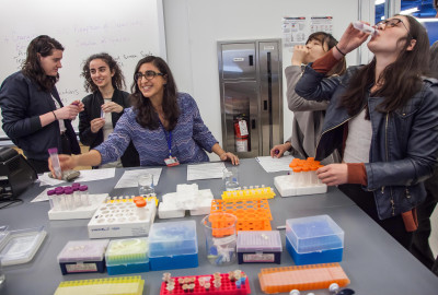 Chamany and Students conducting an experiment at University Lab Open House. Photo by Clarence Elie Rivera.