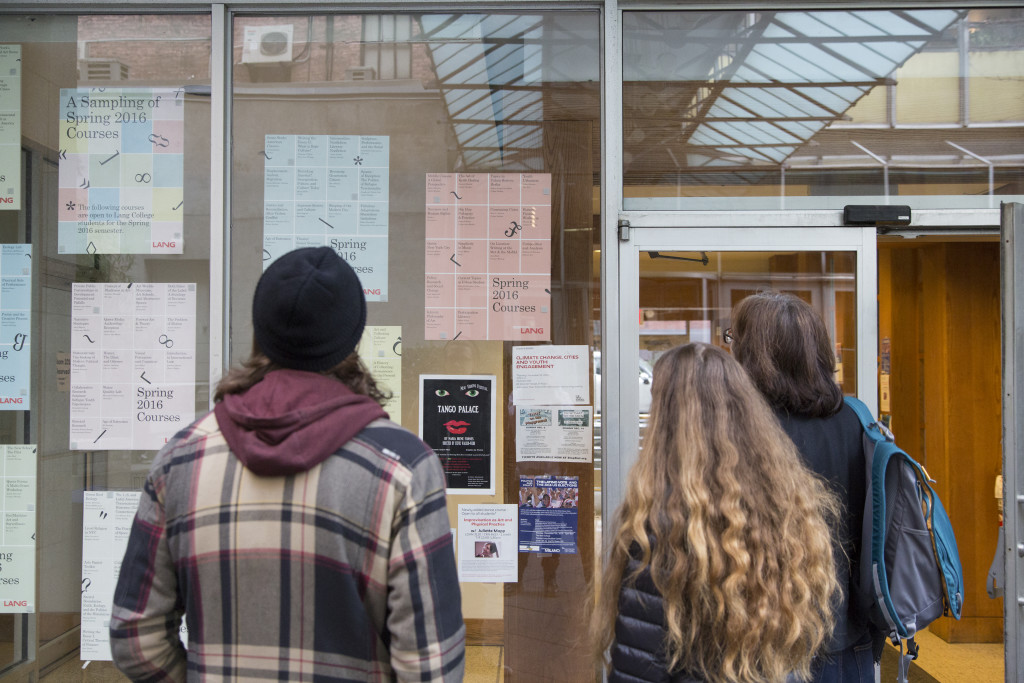 Student tour guide Eric Wade and a prospective student and her mother examine a sampling of Spring 2016 courses in the Lang Courtyard. (Photo/Julianna D'Intino)