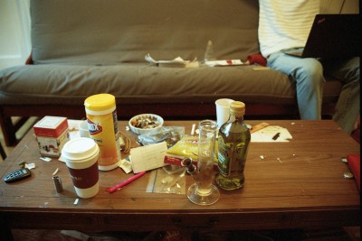 Todd's main room, which was home to a couch, roommate, some friends. Odds and ends scattered his table. photo: morgan young