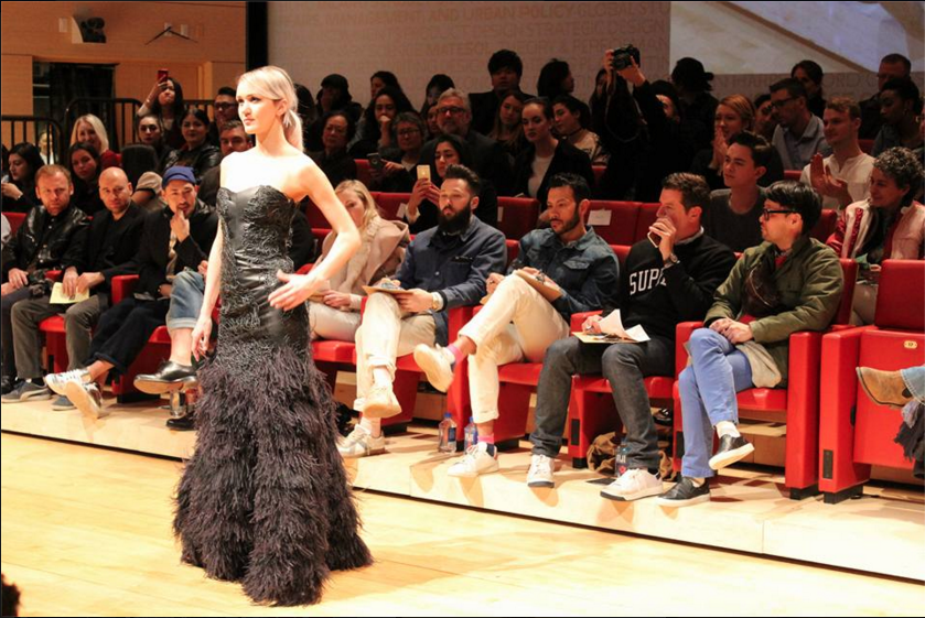 Winning designer, James Chapman's feathered gown attracts the judge's eyes as the sit behind the model. Photo courtesy of Fusion Fashion Show Facebook.