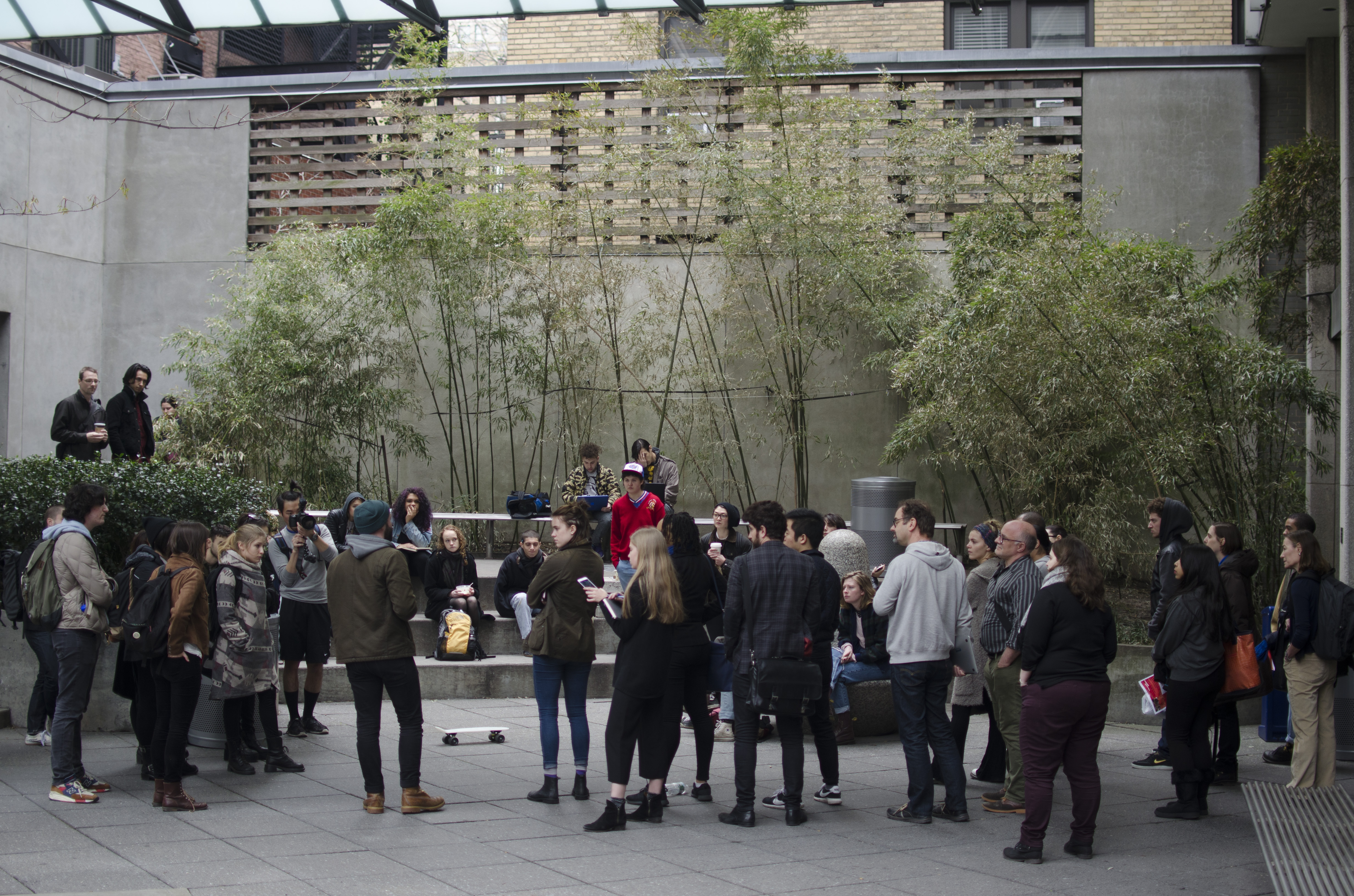 Students and faculty alike filter in and out of the Lang courtyard to discuss the fumigation of the basement on Tuesday, April 5th. (Photo/Kianna Stupakoff)