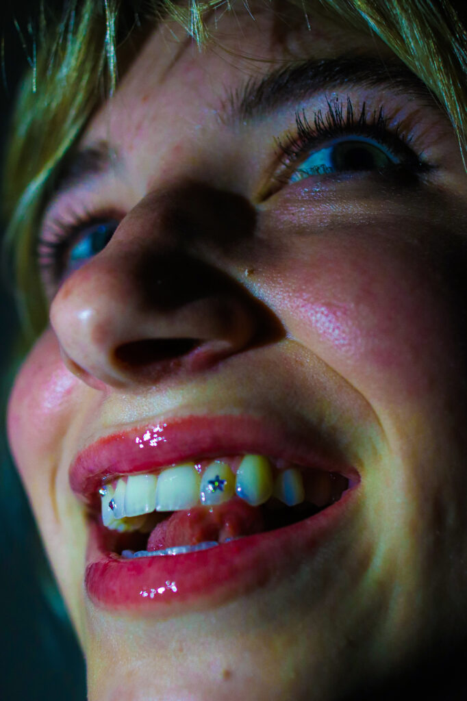 Close up of girl smiling with gems on teeth