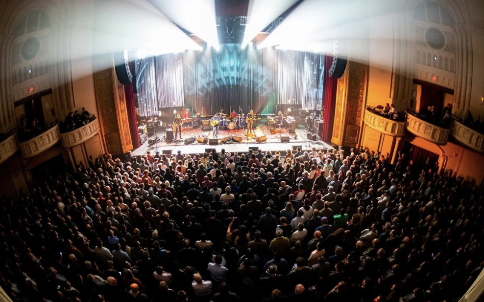 Wilco on stage with the audience filling the pit of the Capitol Theatre.