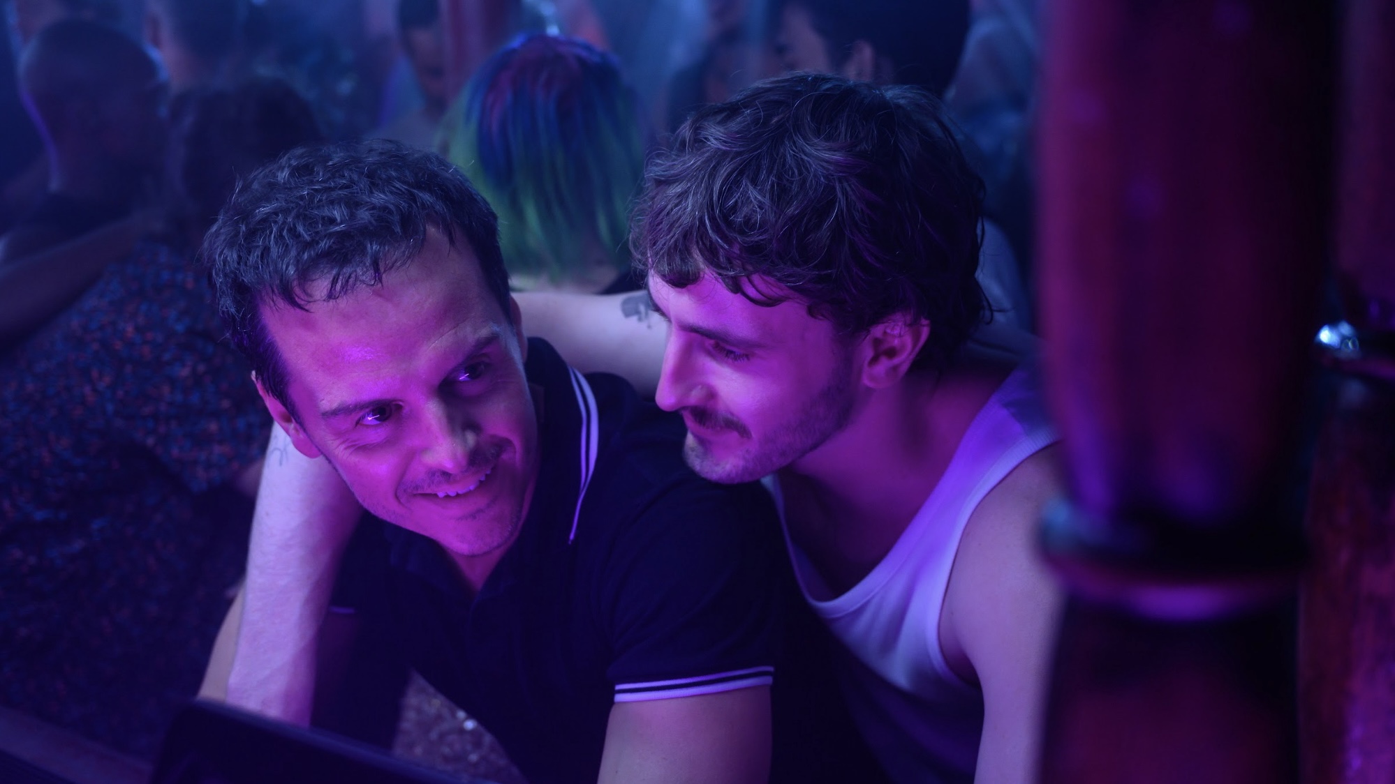 Paul Mescal with his arm over Andrew Scott in a club.