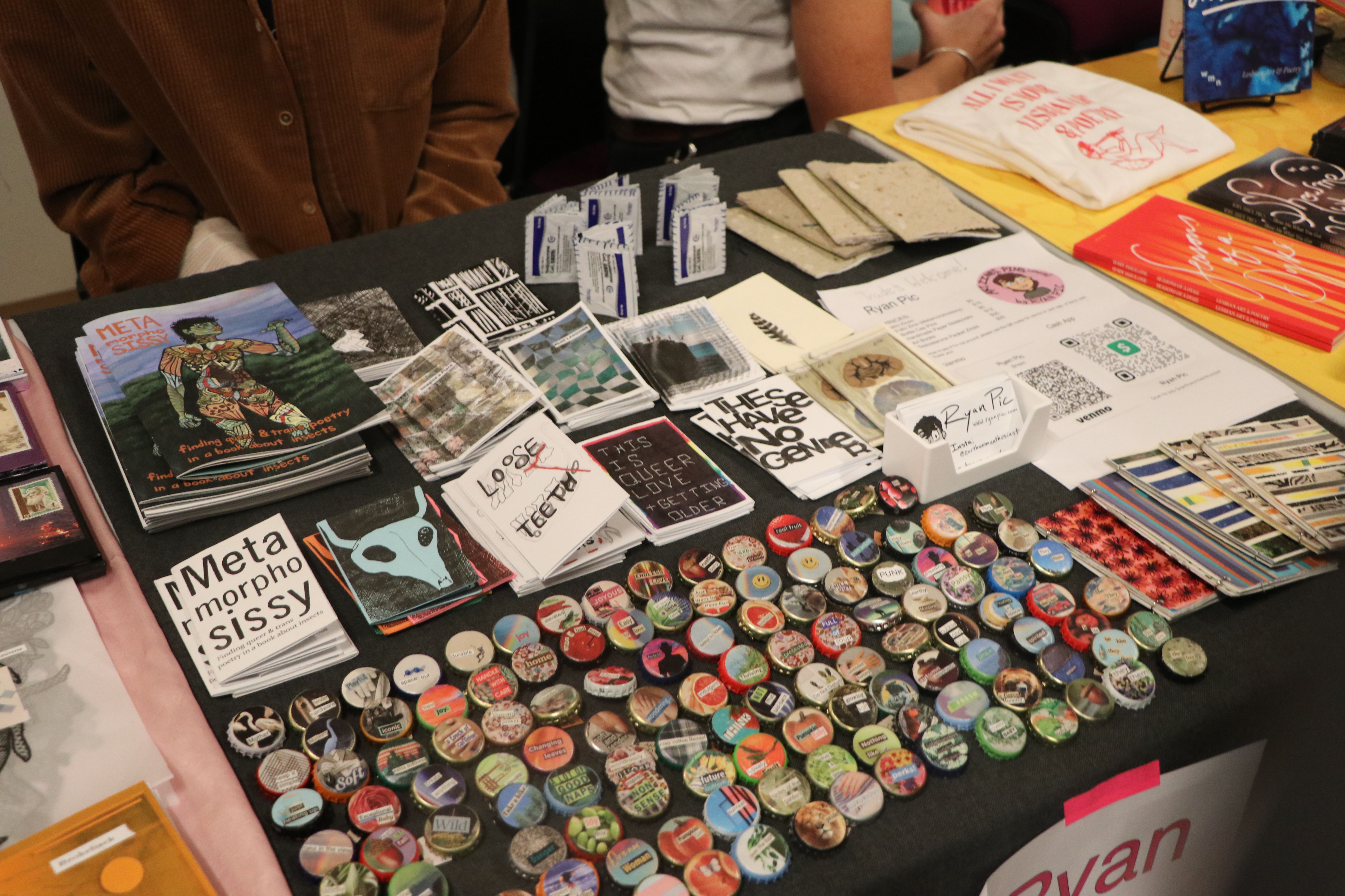 Condoms and zines lay on a table 