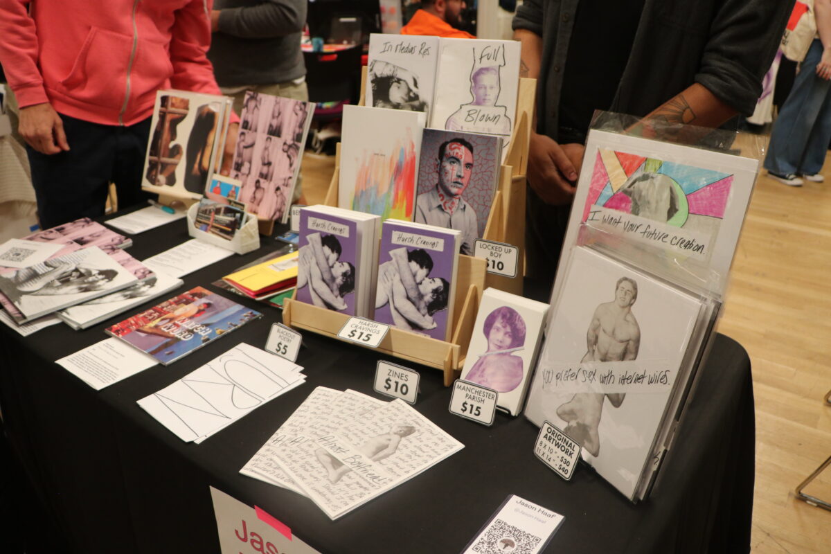 Rows of zines and bookmarks sit on a folding table