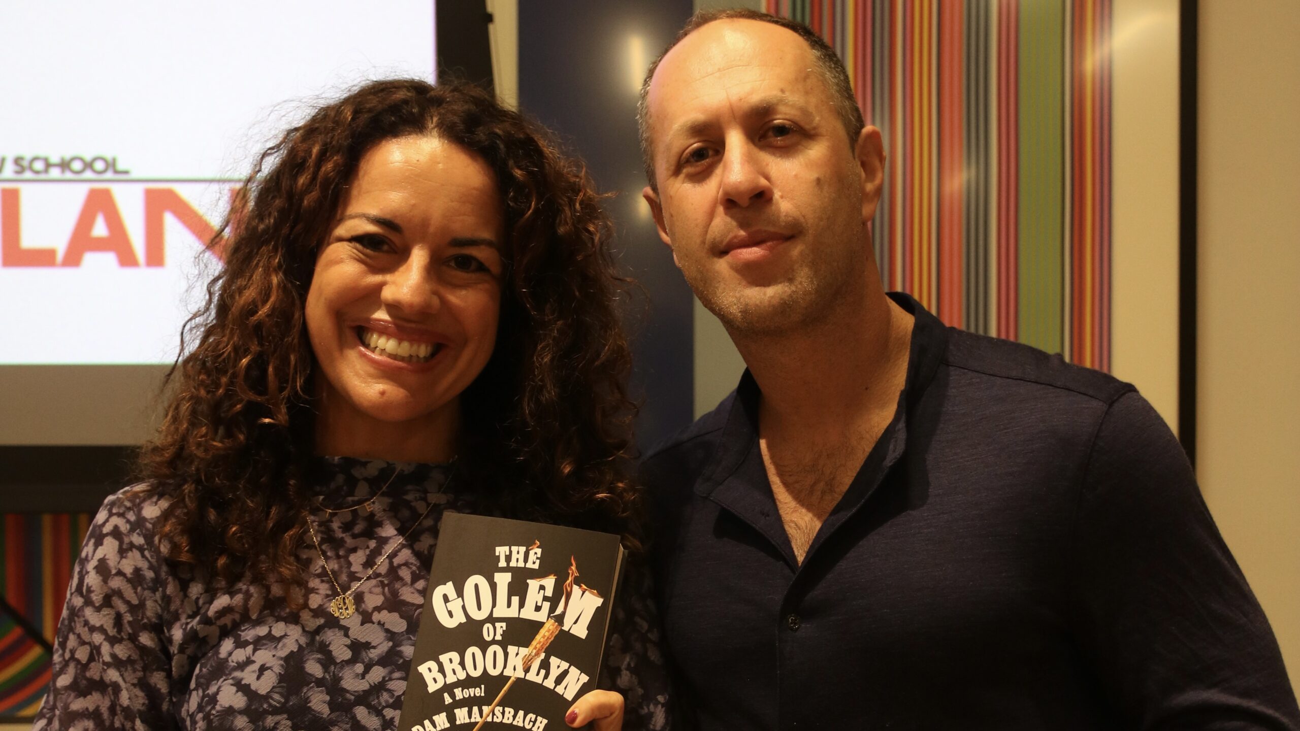 Adam Mansbach and Natalia Mehlman Petrzela with a copy of “The Golem of Brooklyn.”