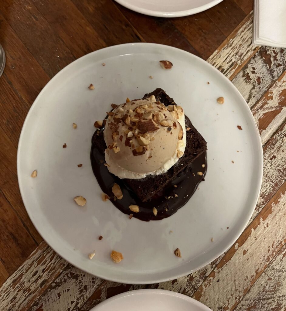 A brownie with ice cream on top.
