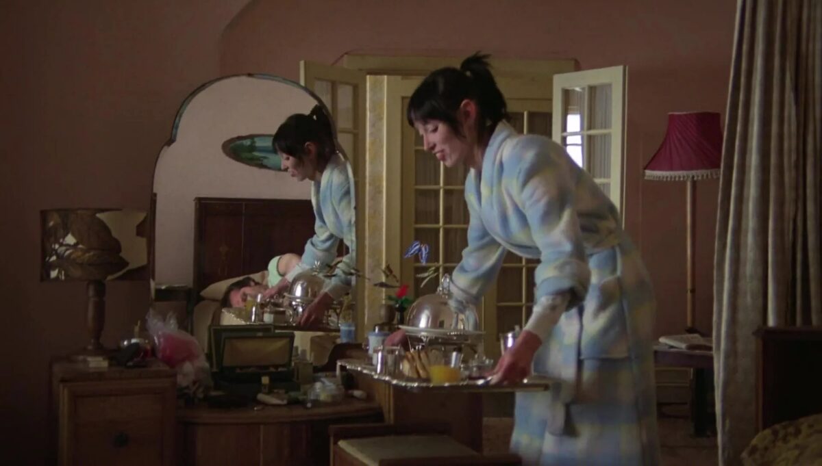 Screen Capture from the movie “The Shining” where Wendy(Shelly Duval) is bringing a room service tray to Jack(Jack Nicholson) in bed.