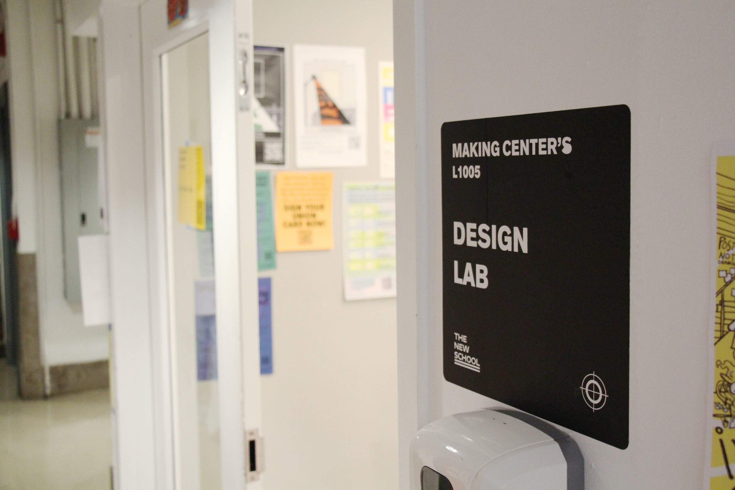 A sign outside of the design lab with a black background and white lettering that reads "Design Lab"
