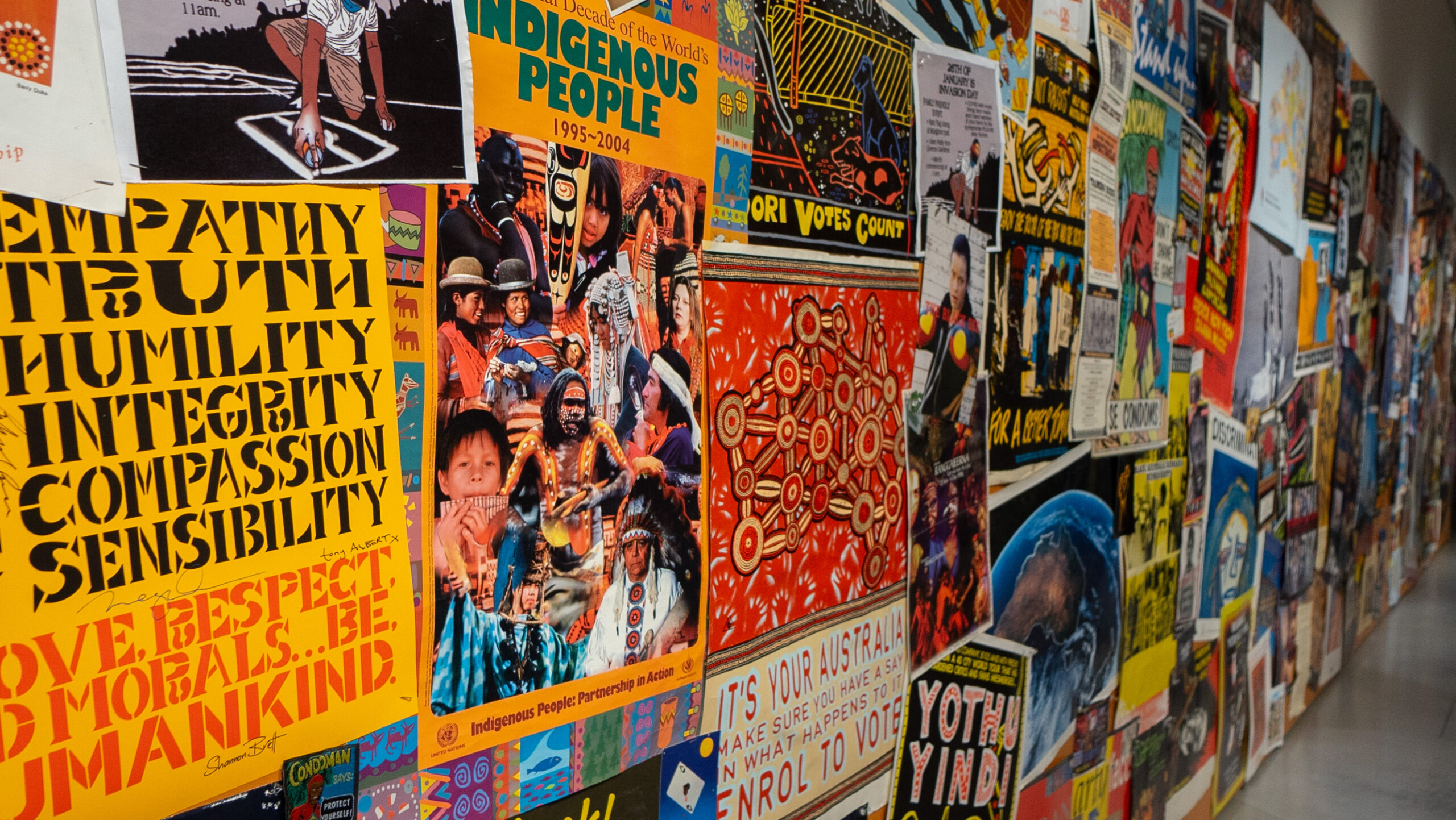 Vibrantly colored posters displayed on the wall of a hallway