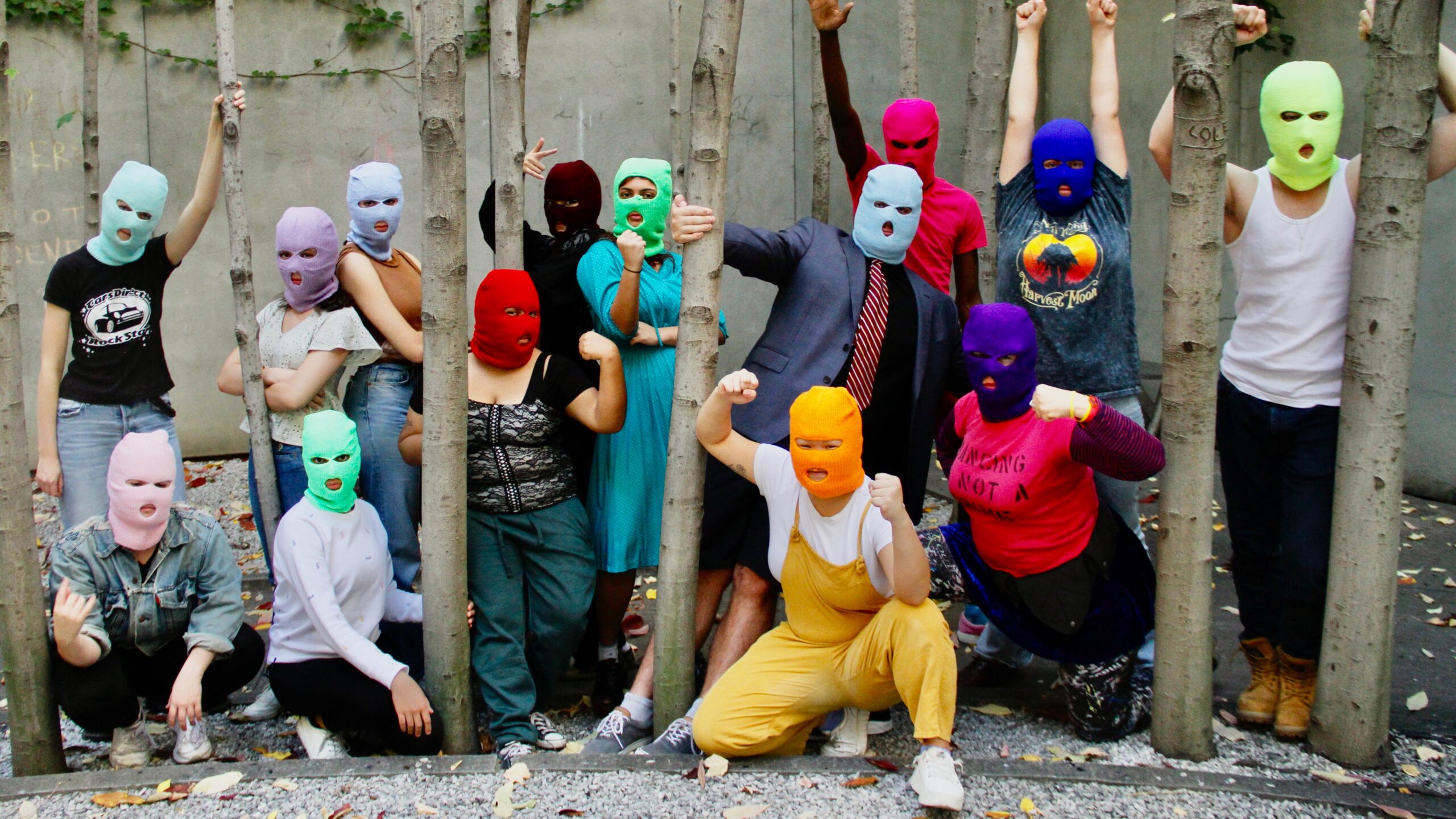 The New School cast of the play “We Are Pussy Riot or Everything is P.R.” pose, while wearing a variety of neon colored ski masks.