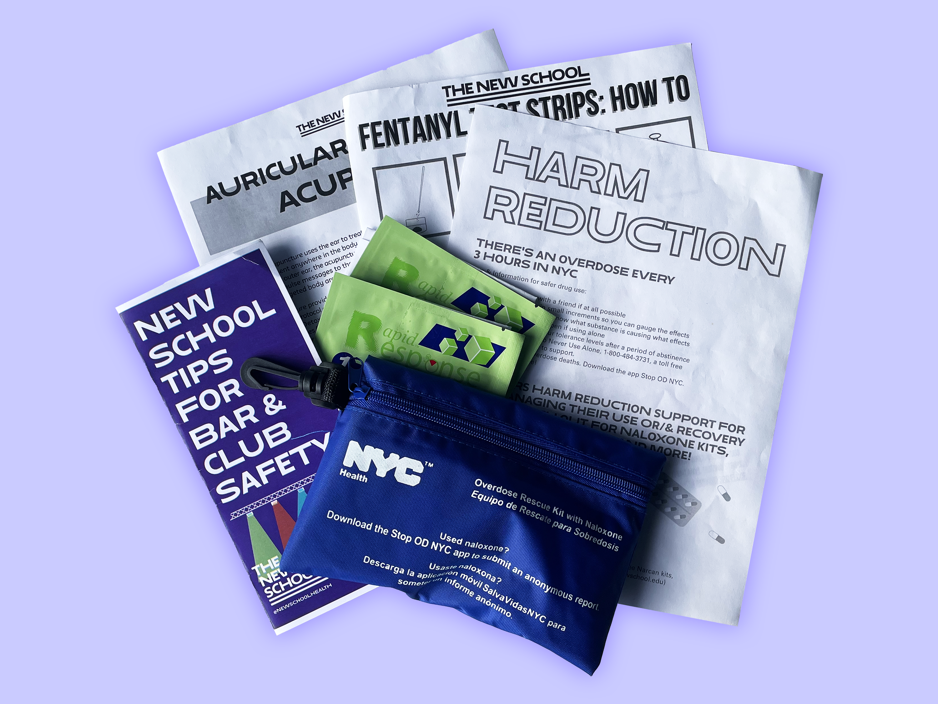 On a light blue background is a spread of harm reduction resources offered by Student Health Services at The New School. There are four pamphlets from left to right reading “New School Tips for Bar and Club Safety,” “Auricular Acupuncture,” “Fentanyl Test Strips: How To,” and “Harm Reduction.” Atop the pamphlets in the middle are two green packets containing fentanyl test strips and a blue bag containing a NYC Department of Health naloxone kit.