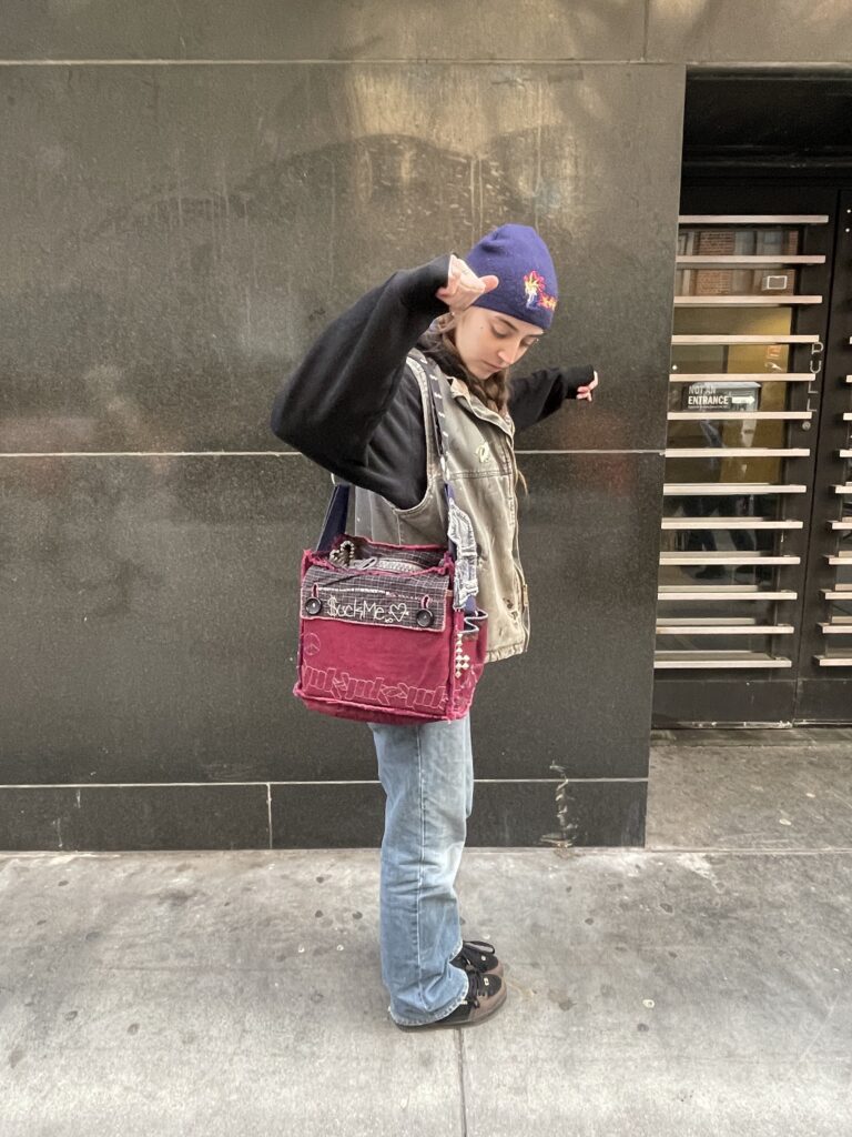 Ally posing with her handmade red embroidered purse.