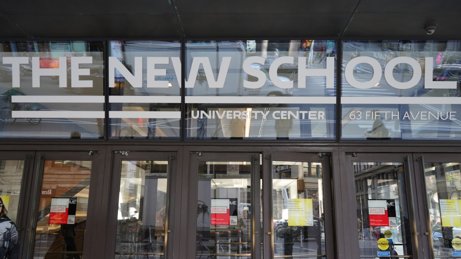 Image of the front doors to the university center. Above the doors it says "the New School"