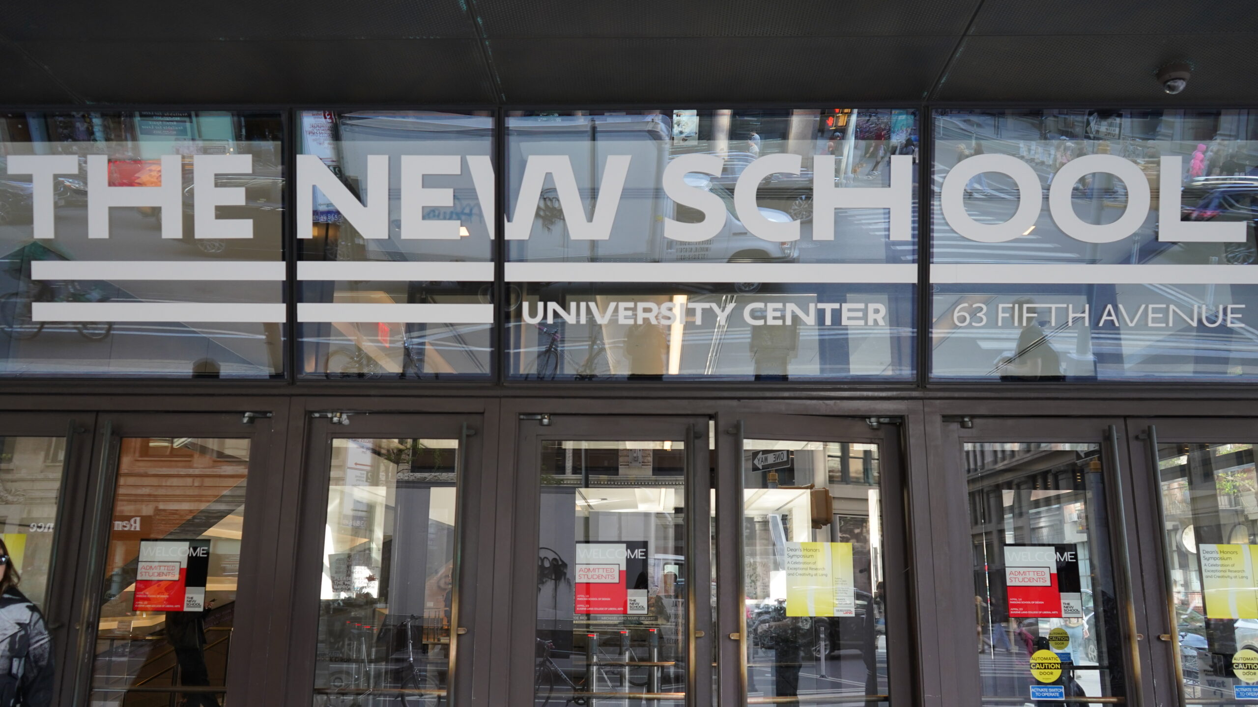 Image of the front doors to the university center. Above the doors it says "the New School"