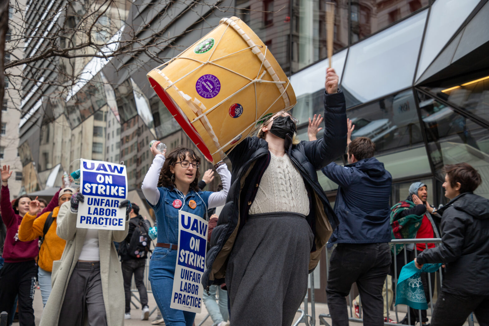 Picketers show signs and use drums in their chants in front of the UC.