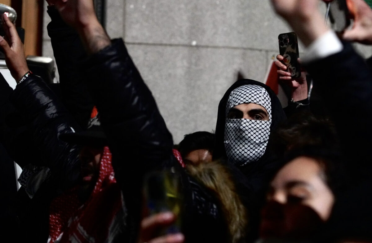 Protesters raise their hands in the air to demonstrate peace during a heated confrontation with NYPD.