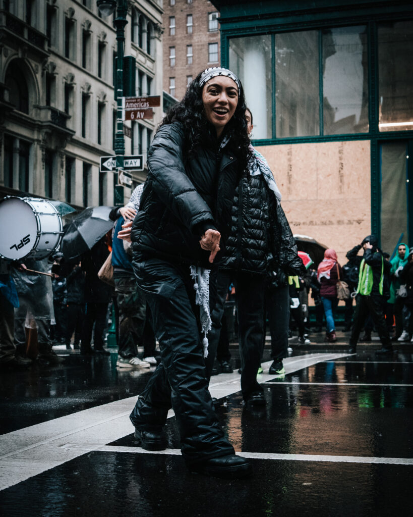 Protester on 6th Ave. laughing and looking at the camera