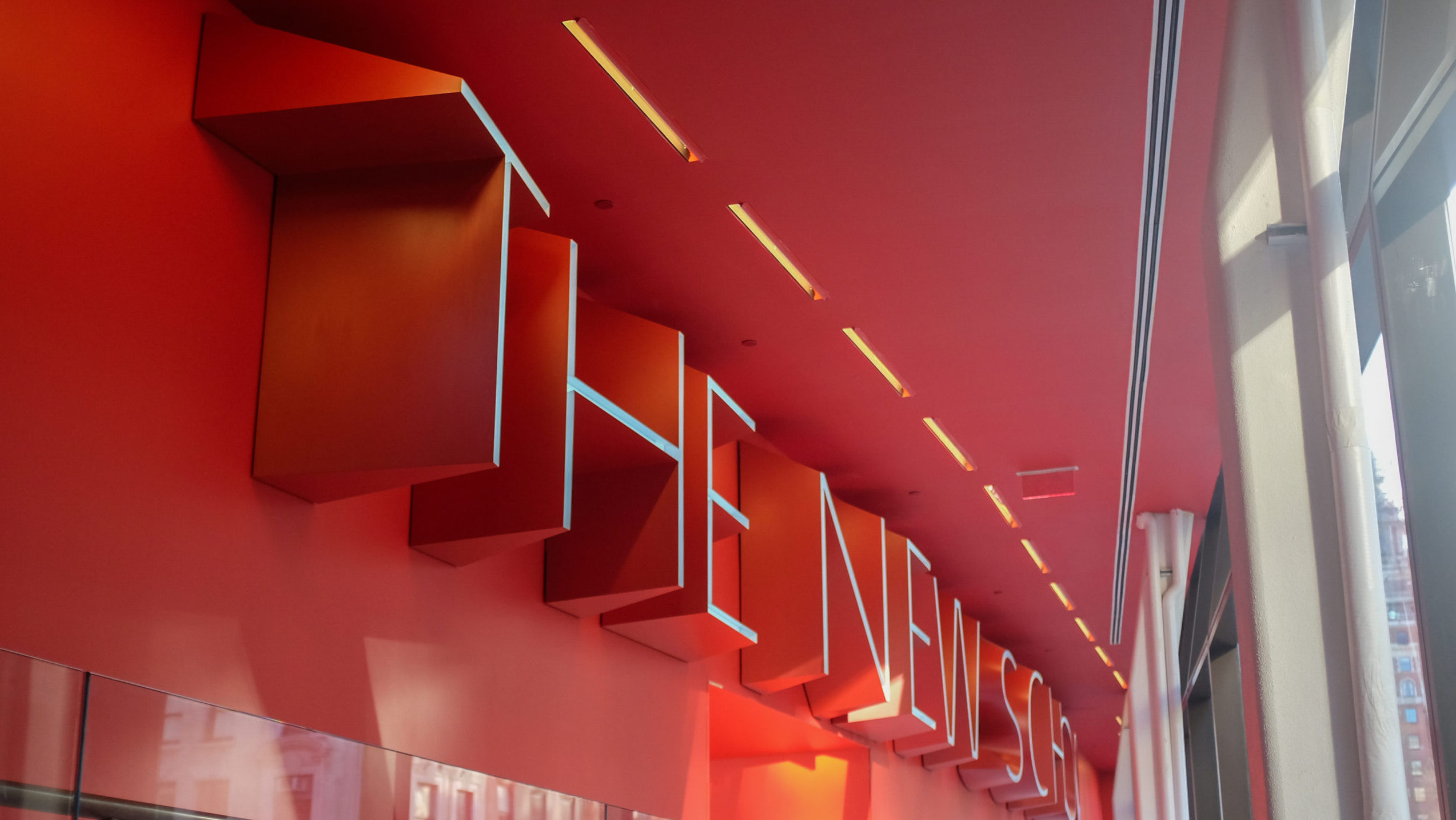 image of "The New School" written in 3D on a red wall in the University Center.