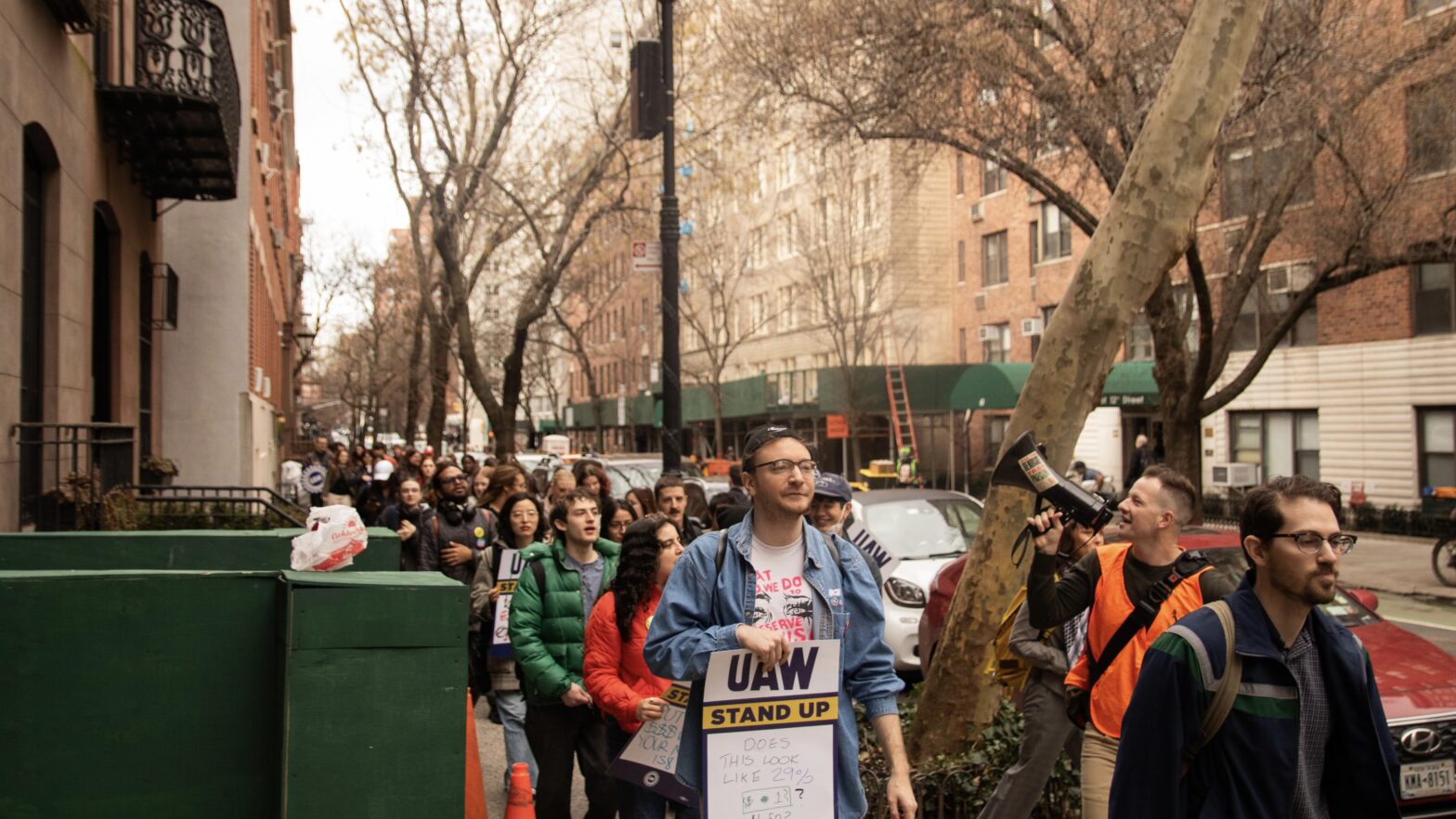 Union members and supporters march with signs.