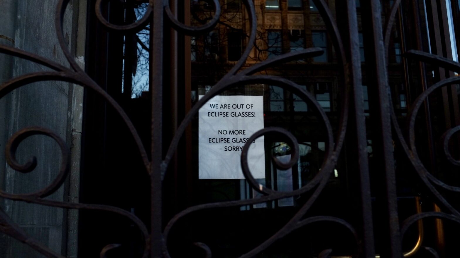 Image of a sign on a door that reads “We are out of eclipse glasses! No more eclipse glasses – sorry”