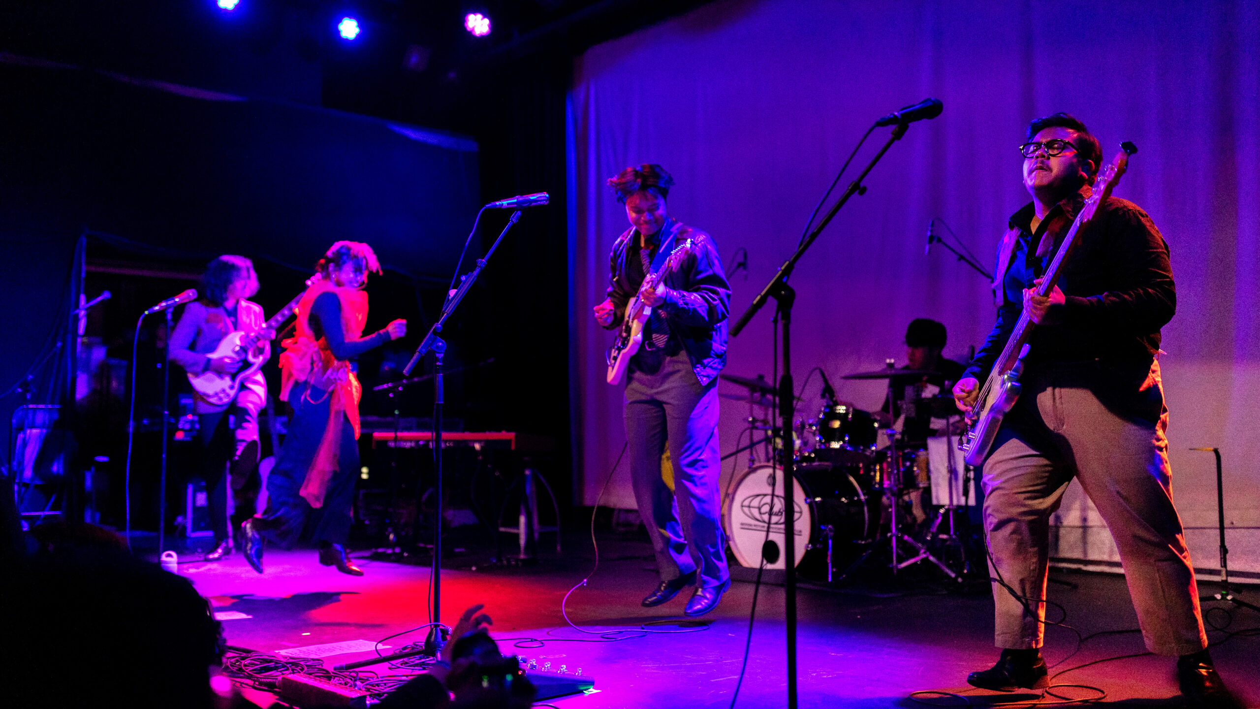 (from left to right) Reality Club band members Fathia “Chia'' Izzati, vocalist and keys, her brother, Faiz Novascotia Saripudin, guitarist and vocalist, Era Patigo, drummer, and Nugi Wicaksono, bass, play under purple and blue lights at the Music Hall of Williamsburg.