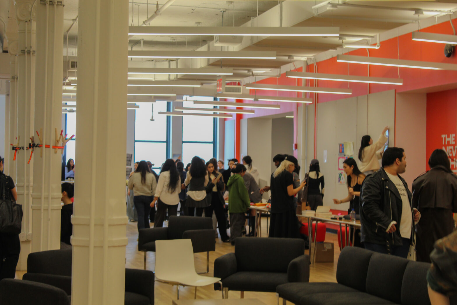 New School Students gather and mingle in the New Student Center on 39 W 13th St. to view senior communication design theses.