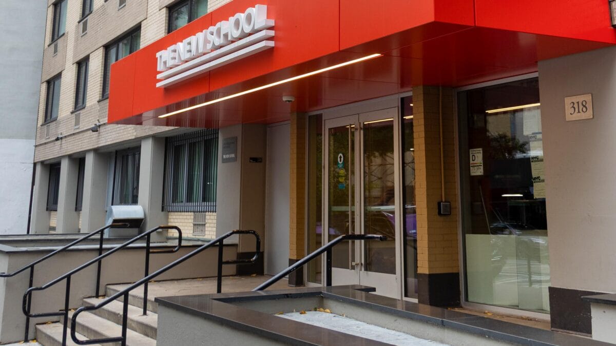 Stuyvesant Park Residence Hall’s front entrance and stoop of with a red awning that reads “The New School.”