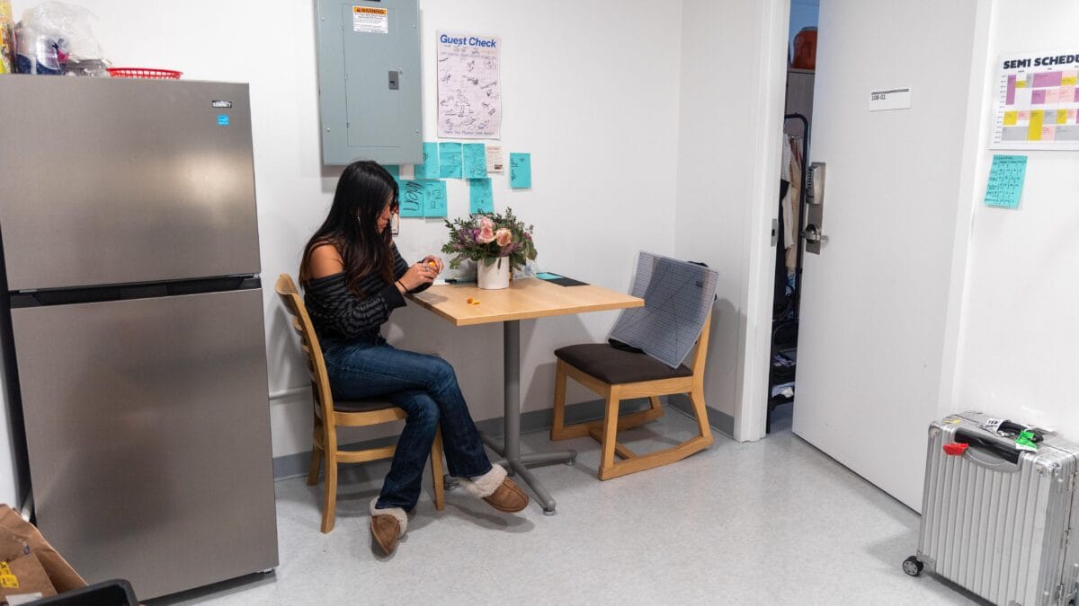 Irene Mok sitting at her suite dining table.