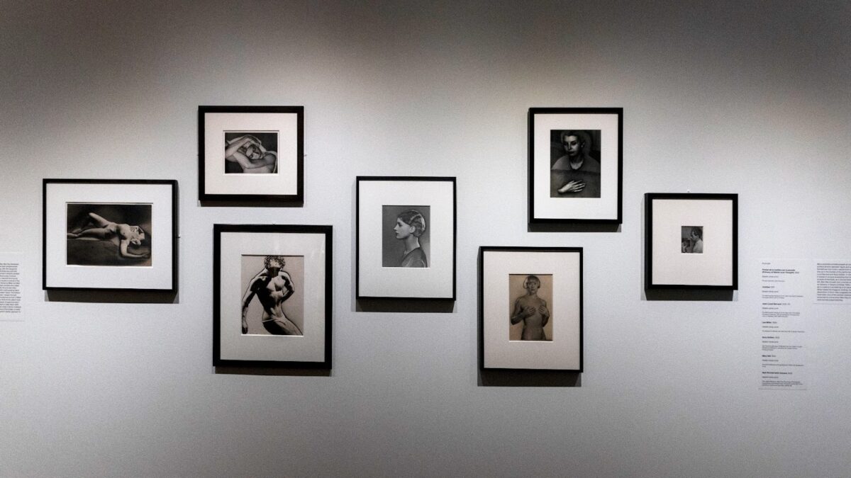 An array of Ray’s photographs against a white wall at the MET.