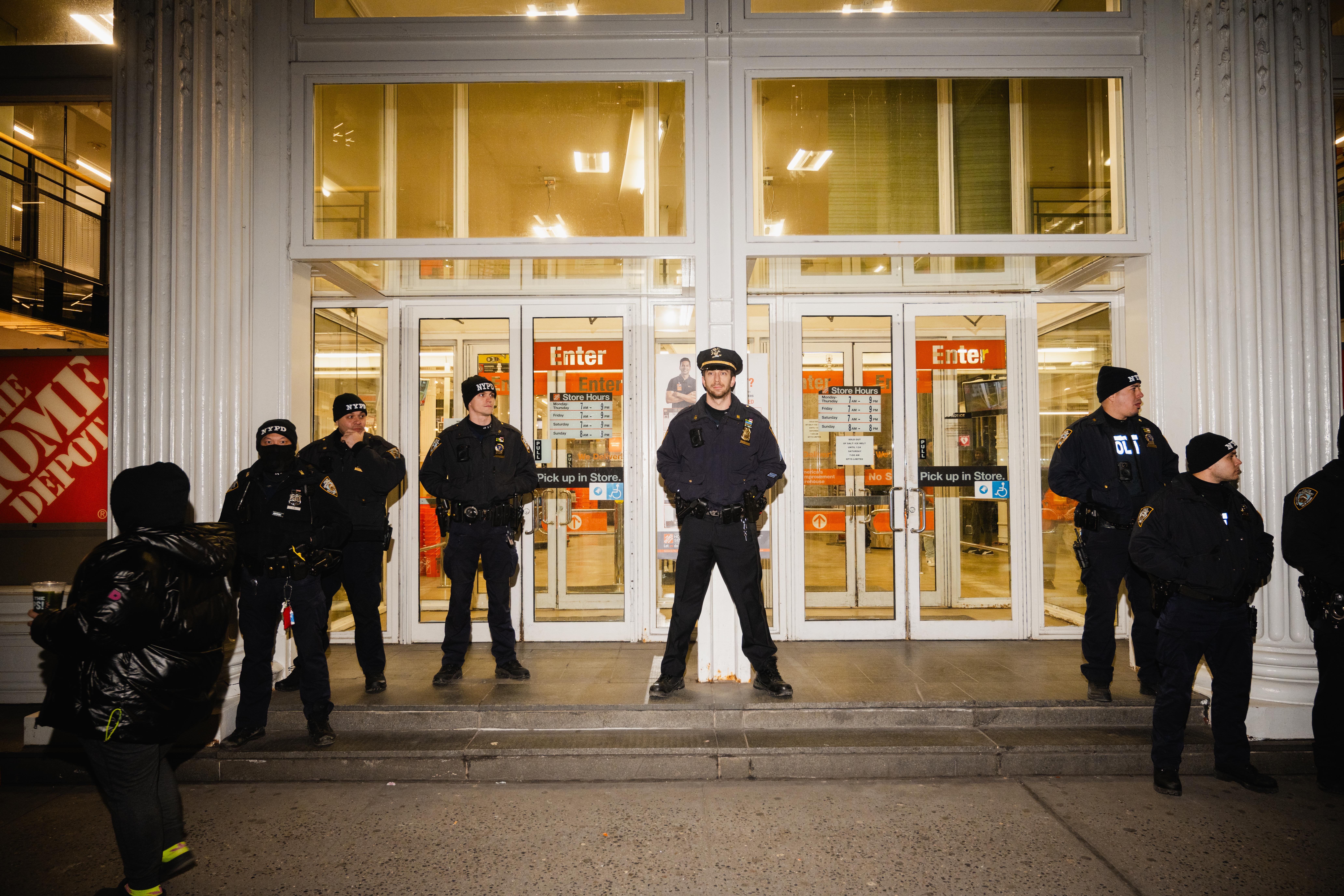 NYPD officers stand in front of the entrance of Home Depot.