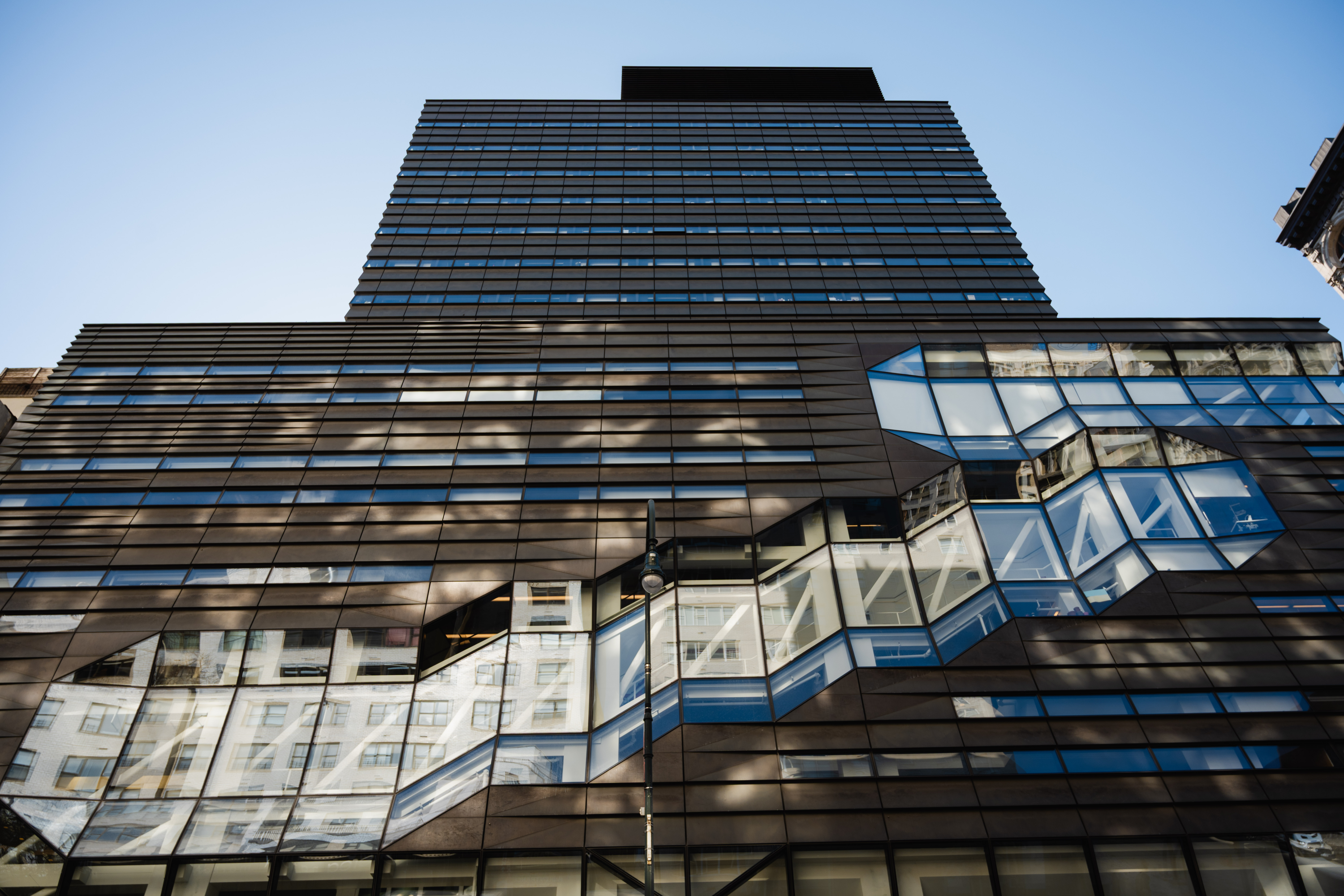 A photo looking up at the University Center with Kerrey Hall visible above.
